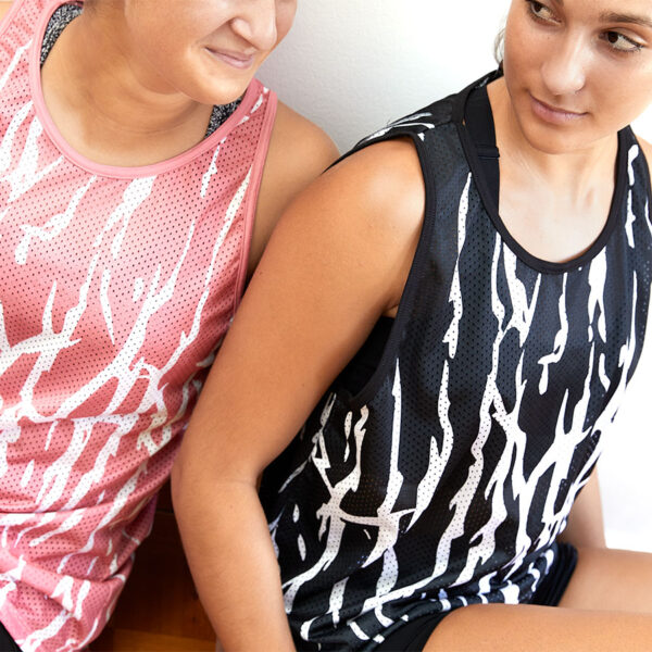 Two people wearing the Human Energy Tank Tops